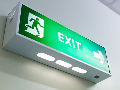 Emergency fire exit lit sign in Wrexham
